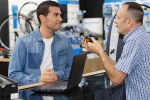 Man returning a defective product to a salesman.