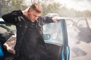 Passenger in the front seat experiencing whiplash from accident.