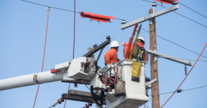 Electrical workers using bucket truck.